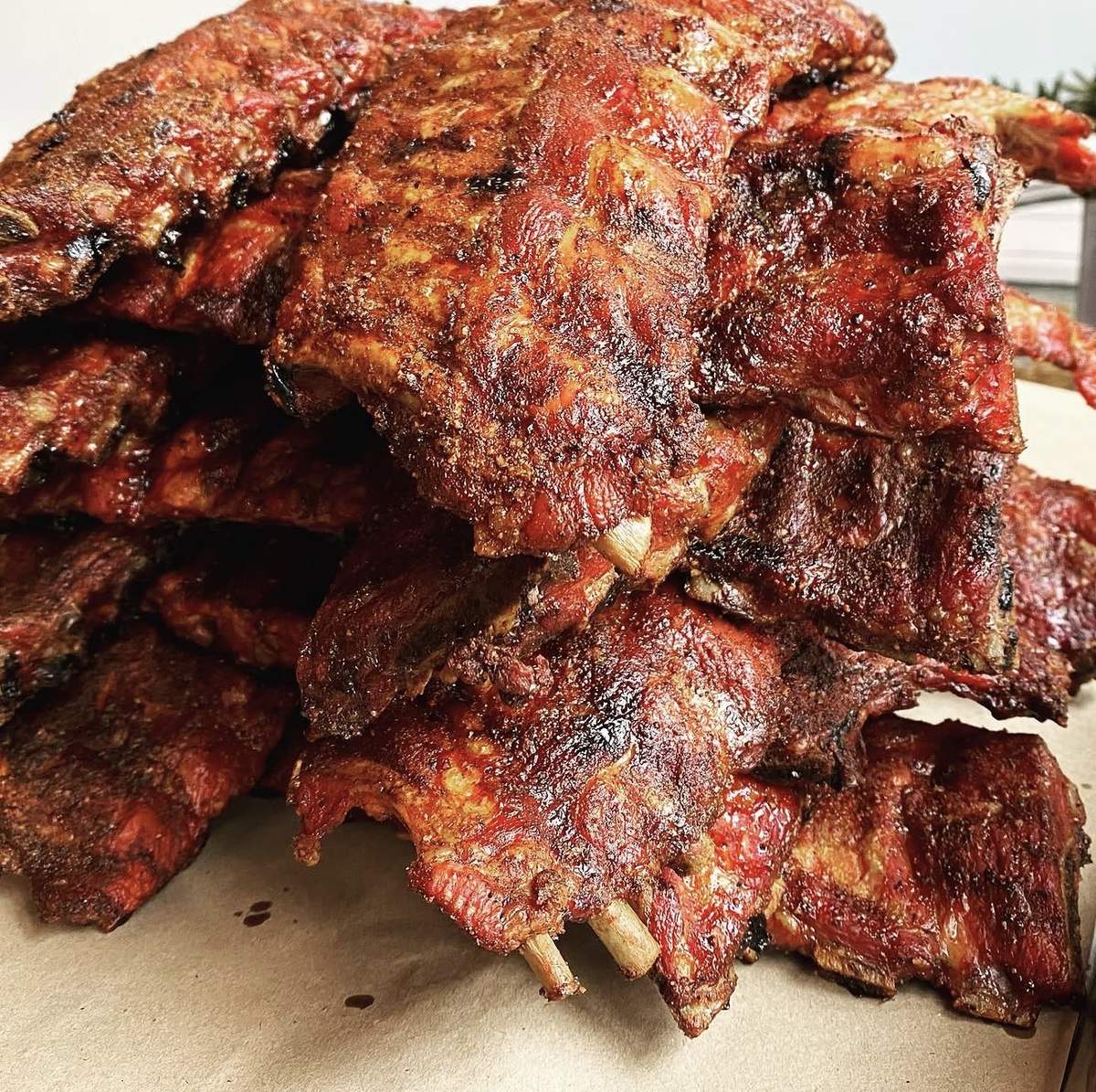 Stacked slabs of smoked baby back ribs at Earl's BBQ drive-thru, Jefferson Park Chicago